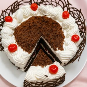 Black forest cake with whipped cream rosettes, chocolate crumb top, red cherries and a chocolate lattice collar