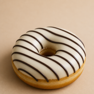 Ring donut with white chocolate icing and dark chocolate drizzle on a warm beige background