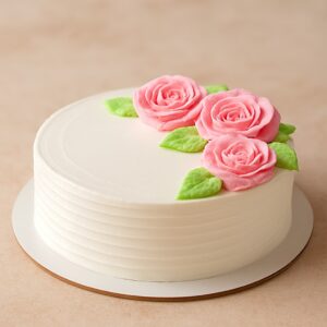 Classic vanilla cake with smooth white buttercream and delicate pink sugar roses